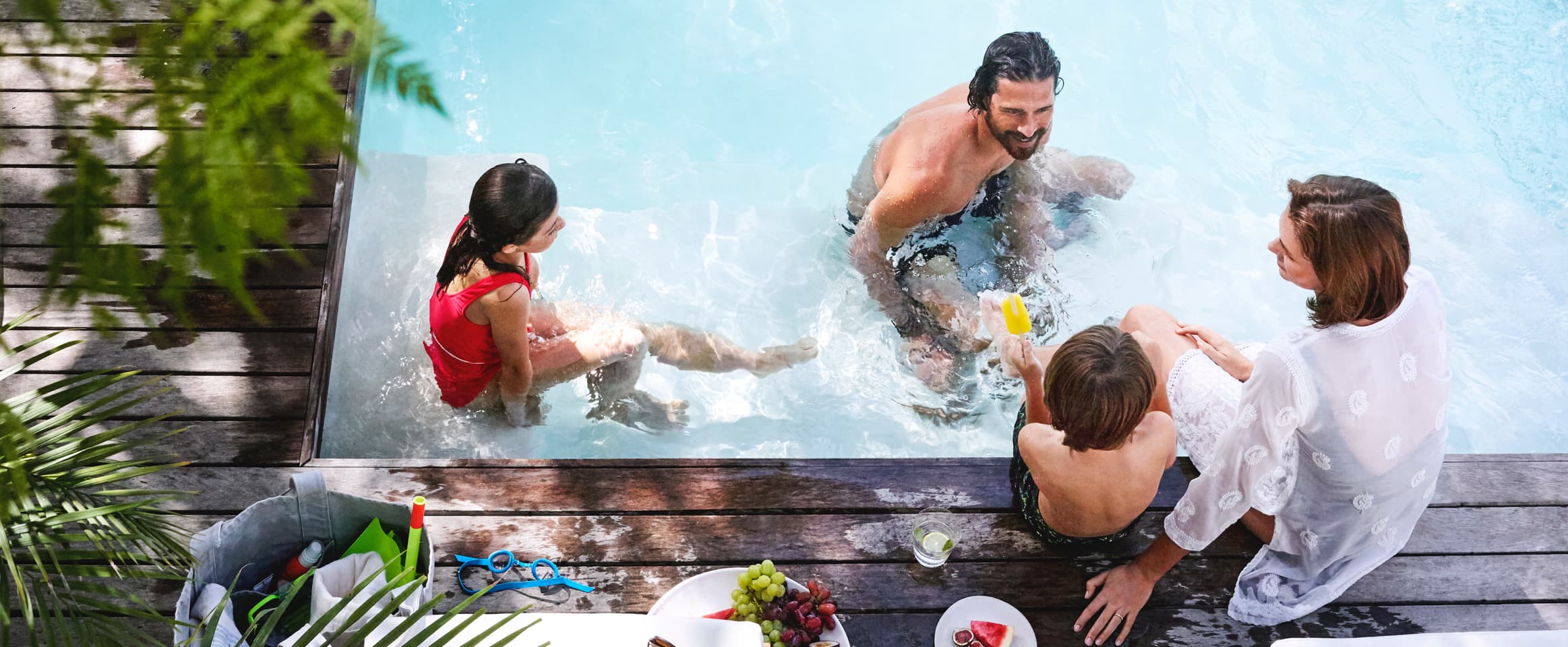 Family eating by private residence pool