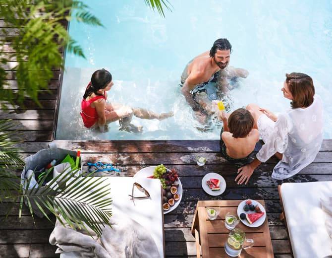 Family eating by private residence pool